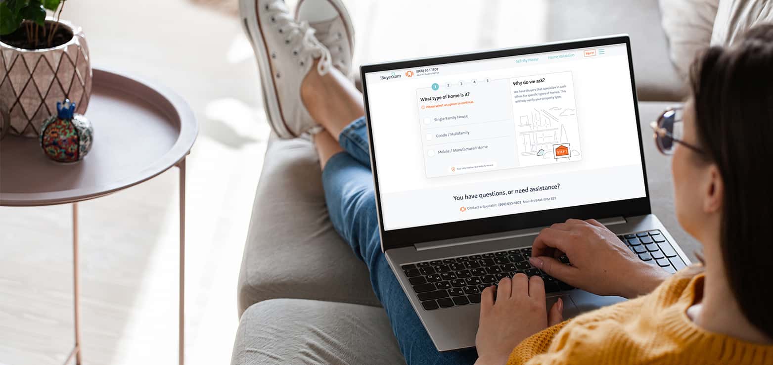 person using laptop to get a free home value estimation